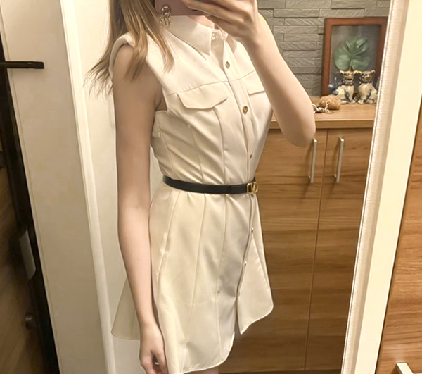 Full-body mirror selfie after surgery in a white dress showing an overall slimmer silhouette.