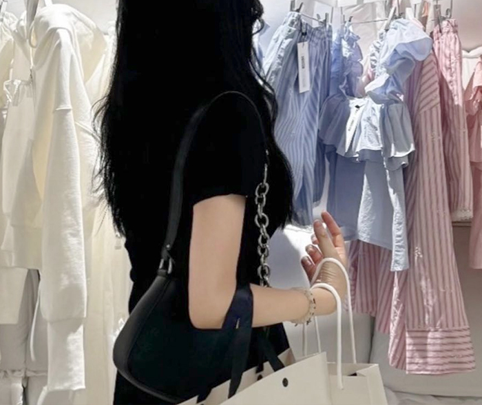 Lucia00 after arm liposuction in Korea, wearing fitted clothes with clearly slimmed upper arms.