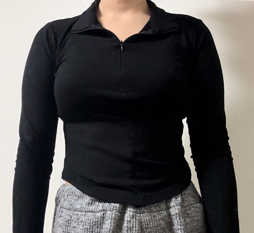 Before arm liposuction of Roroppungppangyi in Korea—front view, long-sleeved black top appears tight on arms.