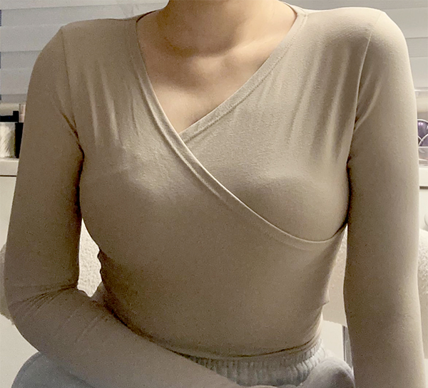After arm liposuction of bbella2 in Korea (Apgujeong)—beige top, seated pose, front view with refined contour.
